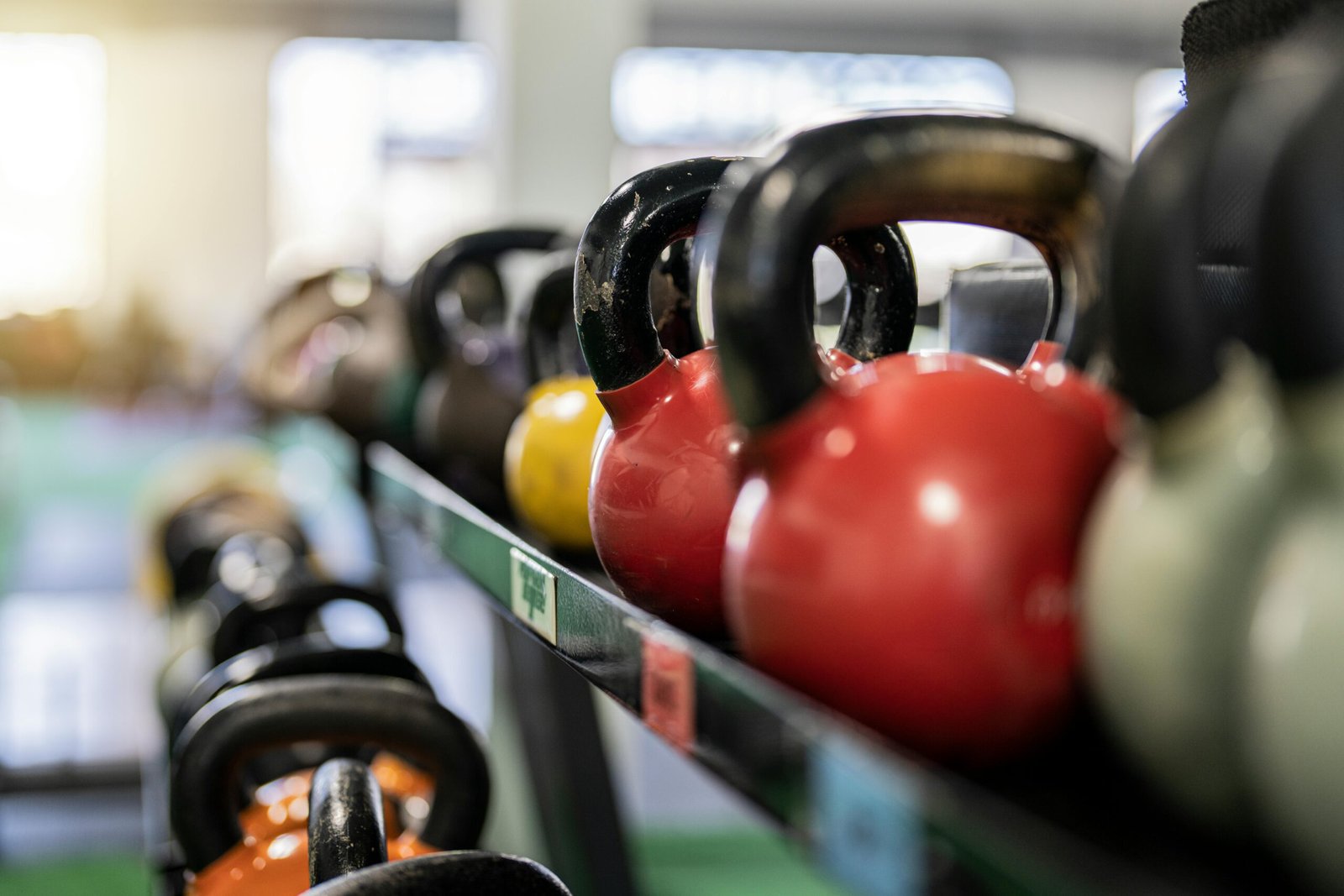 Colourful dumbbells on rack